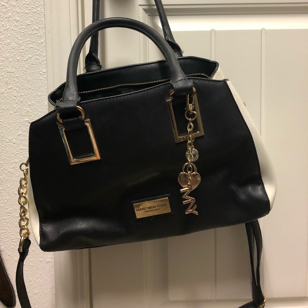 Marc NewYork Andrew Marc black and white purse embellished with gold tone accent